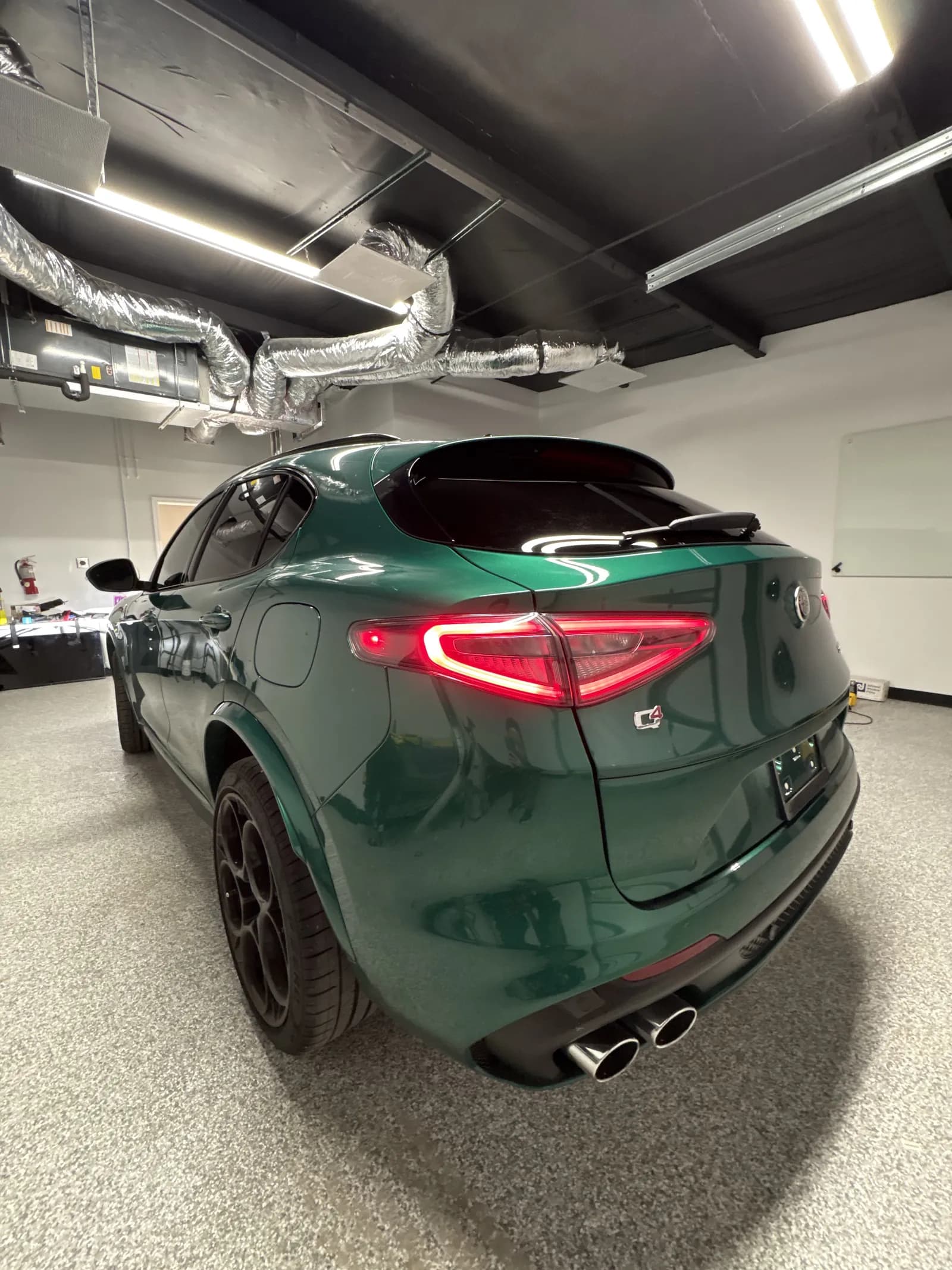 Green Alfa Romeo Stelvio QV with dark ceramic tint