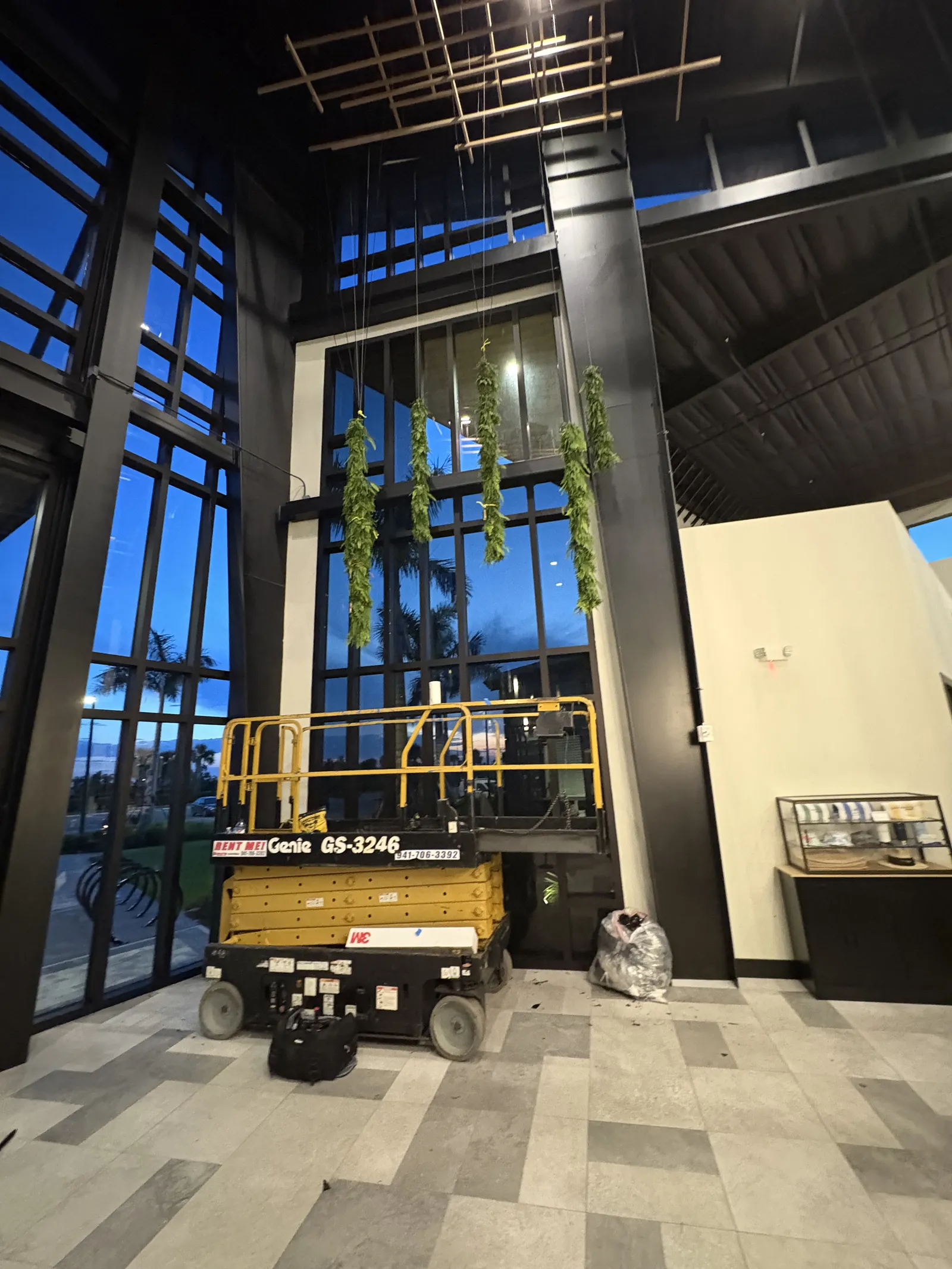 Two-story commercial lobby glass film installation with lift