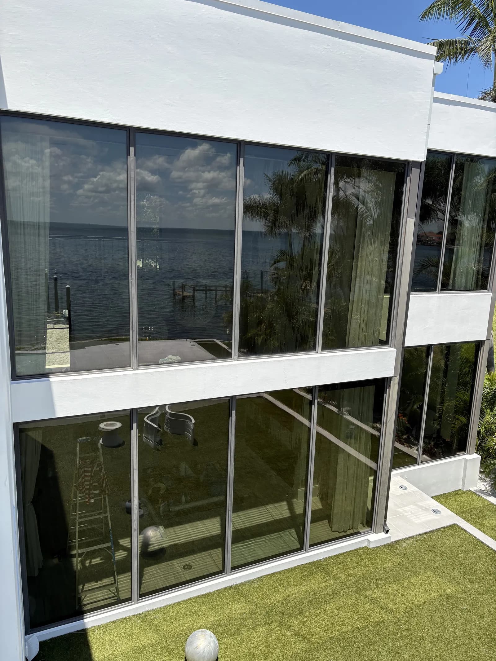 Waterfront home floor-to-ceiling tinted windows
